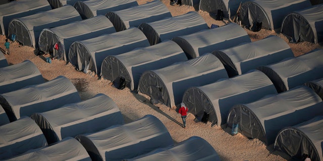 In this Oct, 17, 2014, file photo, Syrian Kurdish refugees are seen at a refugee camp in Suruc, on the Turkey-Syria border.