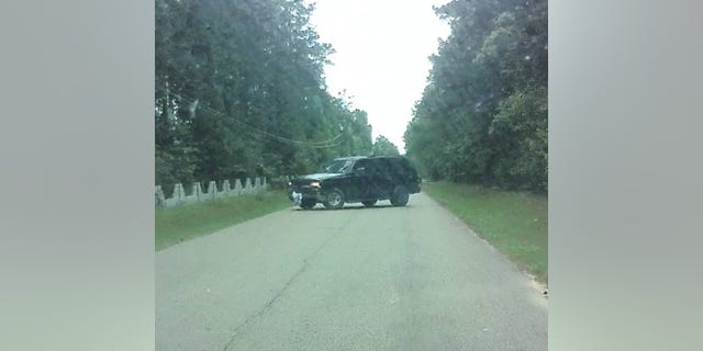 The employee told authorities the vehicle started driving towards her before blocking the road.