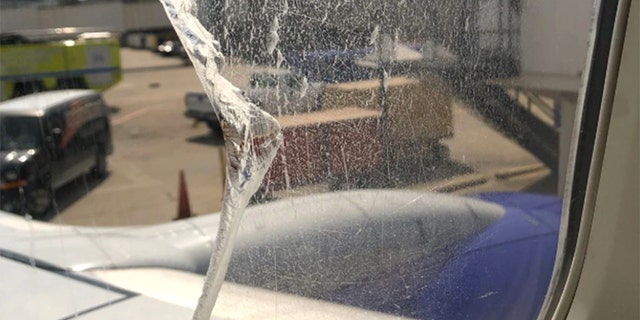 The window appeared to have a large, jagged crack following the incident.