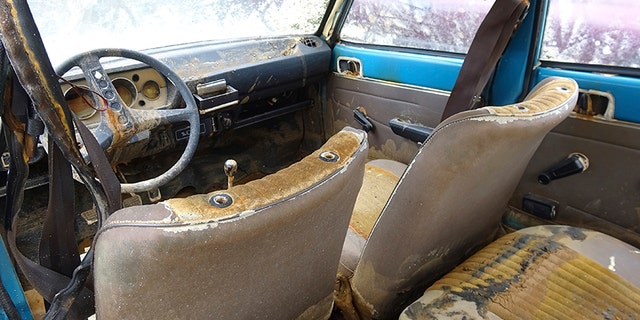 An interior view of a Peugeot 104, which was recovered this week 38 years after it was stolen, stored in a garage in Chalons-en-Champagne, eastern France, Friday, Sept. 1, 2017. A blue Peugeot 104 stolen in the heart of France's Champagne country in 1979 is being reunited with its owner - 38 years later - after French police pulled it, in surprisingly good shape but teeming with crayfish, from a murky swamp. (AP Photo/Chris den Hond)