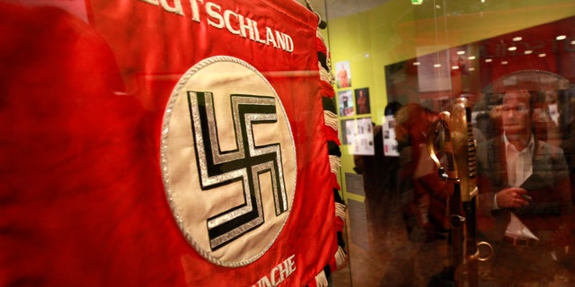 File photo - A flag with the Nazi swastika is pictured at the media preview of "Hilter und die Deutsche Volksgemeinschaft und Verbrechen" (Hitler and the German Nation and Crime) at the Deutsche Historisches Museum (German Historical Museum) in Berlin Oct. 13, 2010. The words on the flag read "Germany wake up". (REUTERS/Fabrizio Bensch)