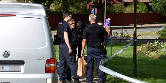 In this Tuesday, July 31, 2018 photo, police near the scene of a robbery at the Strangnas Cathedral, in Strangnas, Sweden.
