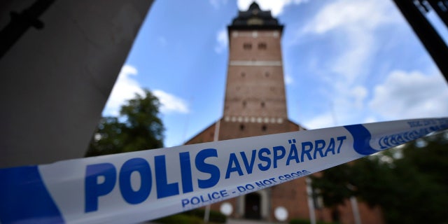 In this Tuesday, July 31, 2018 photo, a police cordon near the scene of a robbery at the Strangnas Cathedral, in Strangnas, Sweden.