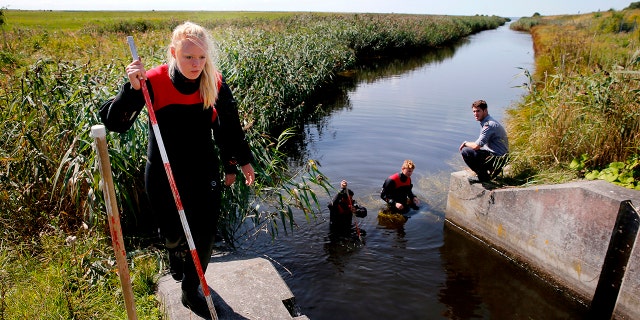 Police and other authorities search a waterway for body remains related to the ongoing Kim Wall murder investigation at the west coast of Amager close to Copenhagen, Denmark on Aug. 23, 2017.