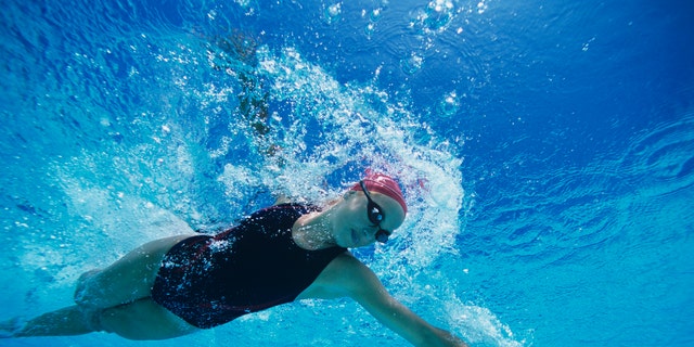 Female Swimmer Swimming Mid-stroke