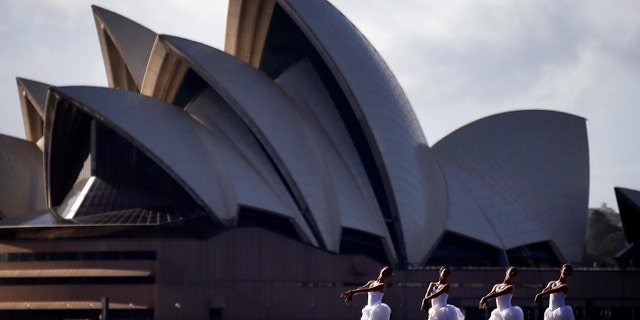 File photo - Ballerinas from The Australian Ballet perform on a floating platform, during a promotional event in front of the Sydney Opera House, February 18, 2015. The event was to promote the Australian Ballet's upcoming performance of Swan Lake opening on Feb. 20. (REUTERS/David Gray)
