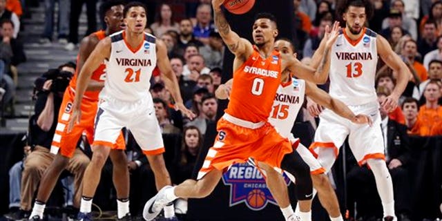 Syracuse's Michael Gbinije (0) grabs a loose ball during the first half of a college basketball game against Virginia in the regional finals of the NCAA Tournament, Sunday, March 27, 2016, in Chicago. (AP Photo/Charles Rex Arbogast)