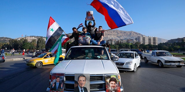 A convoy of cars with pro-government supporters in Damascus.