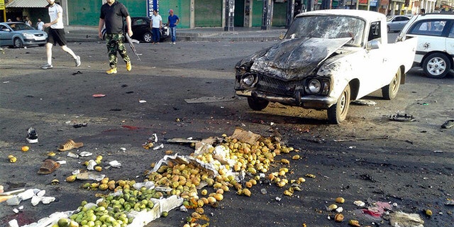 July 25, 2018: Syrians inspect the site of a suicide attack in Sweida.