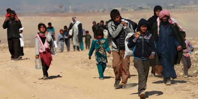 Displaced Iraqis flee their homes due to fighting between Iraqi special forces and Islamic State militants.