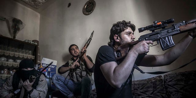 Oct. 29, 2012: In this photo, a rebel sniper aims at Syrian army positions in the Aleppo Jedida district, Syria.