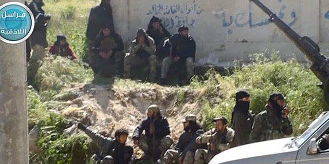This image posted on the Twitter page of Syria's Al Qaeda-linked Nusra Front on Saturday, April 25, 2015, which is consistent with AP reporting, shows Nusra Front fighters in the town of Jisr al-Shughour, Idlib province, Syria.