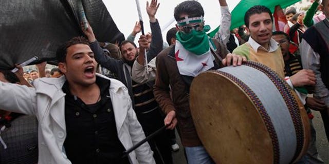 Nov. 18, 2011: Protesters chant anti-Syrian regime slogans in Tahrir Square, the focal point of the uprising that ousted President Hosni Mubarak, in Cairo, Egypt, Friday, Nov. 18, 2011. Thousands of Egyptians are rallying in Cairo's Tahrir square, with Islamists in the forefront, in a protest against what they say are attempts by the country's military rulers to reinforce their powers.