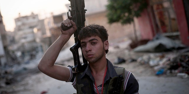 Sept. 19, 2012: A Free Syrian Army fighter soldier stands at the front line in the Amariya district in Aleppo, Syria.