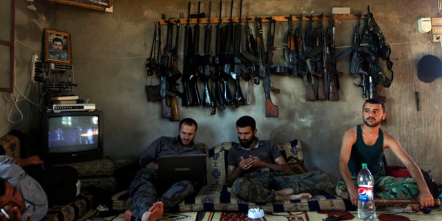 June 12, 2012: Free Syrian Army fighters sit in a house on the outskirts of Aleppo, Syria.