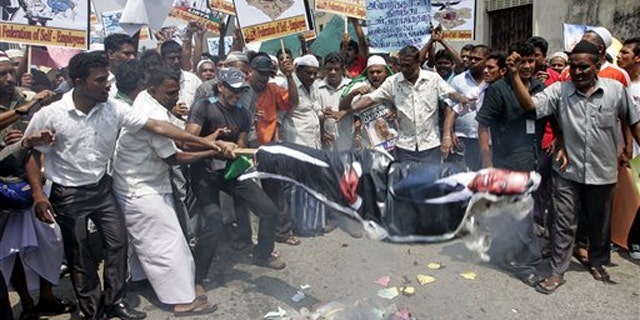 Sri Lankan Muslims burn an effigy of President Obama during a protest rally against the allied forces' air strike in Libya, in Colombo, Sri Lanka, March 25.