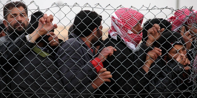 Jan. 28, 2013: Newly arrived Syrian refugees wait for their turn to receive mattresses, blankets and other supplies, and to be assigned to tents, at the Zaatari Syrian refugees camp in Mafraq, near the Syrian border with Jordan. UN officials say a spike in Syrian refugees fleeing to Jordan in the past week has seen about 21,000 new arrivals with Jordans Zaatari refugee camp now hosting about 83,000 registered refugees.