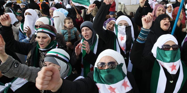 Dec. 9, 2011: Syrians living in Jordan shout slogans during a demonstration against Syrian President Bashar al-Assad after Friday prayers in front of the Syrian Embassy in Amman.