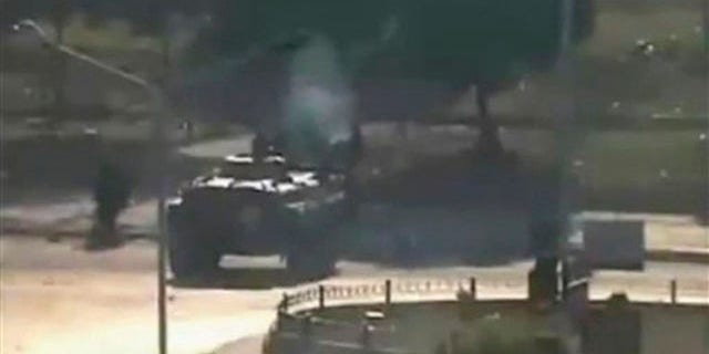 This Aug. 3 file image posted on the Internet by Shaam News Network shows what they purport to be a military tank on the streets of the city of Hama, Syria.