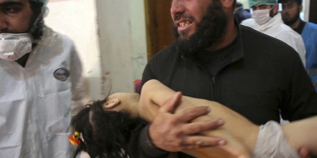April 4: A man carries a child following a suspected chemical attack, at a makeshift hospital in the town of Khan Sheikhoun, northern Syria.