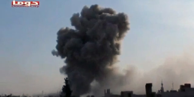 Nov. 9, 2012: In this image taken from video obtained from Shaam News Network, smoke is shown rising from a residential area of the city during bombing from military warplanes, in Douma, Syria.