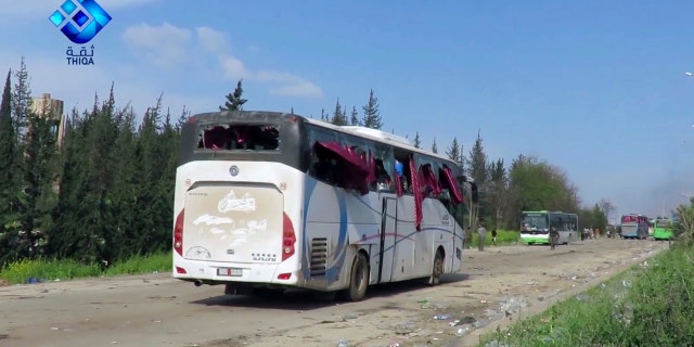 This frame grab from video provided by the Thiqa News Agency, shows buses damaged by a blast at the Rashideen area, a rebel-controlled district outside Aleppo city, Syria, Saturday, April. 15, 2017