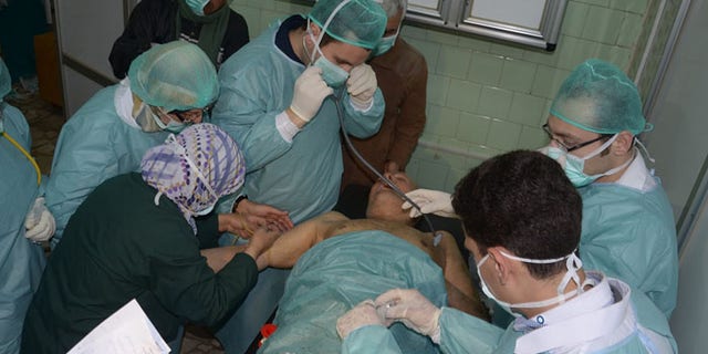 In this photo released by the Syrian official news agency SANA, a Syrian victim who suffered an alleged chemical attack receives treatment at a hospital in Aleppo. (AP Photo/SANA)