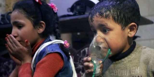 This image released early Sunday, April 8, 2018 by the Syrian Civil Defense White Helmets, shows a child receiving oxygen through respirators following an alleged poison gas attack in the rebel-held town of Douma, near Damascus, Syria.