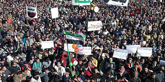 In this citizen journalism image provided by the Local Coordination Committees in Syria and released Friday, Feb. 3, 2012, anti-Syrian regime protesters march in Bensh, Idlib Province, northern Syria.