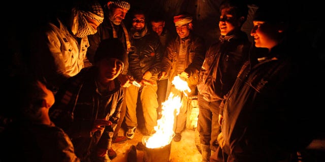 Dec. 12, 2013: Syrian refugees from the town of Qara gather around a fire to keep themselves warm in a Syrian refugee camp on the Lebanese border town of Arsal, in eastern Bekaa Valley. (Reuters)