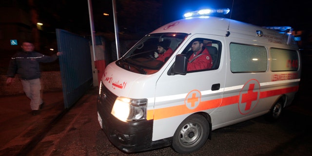 March 2, 2012: A Lebanese Red Cross ambulance follows Lebanese police vehicles carrying two injured French journalists who were trapped at Baba Amr neighborhood in Homs province after they were wounded by the Syrian government forces shelling, to enter the hospital of Hotel Dieu, in Beirut, Lebanon.