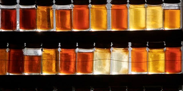 Eighteen different grades of maple syrup are displayed in East Montpelier, Vt. as the state's lawmakers are considering whether to drop the state's traditional maple labeling system in favor of an international one.