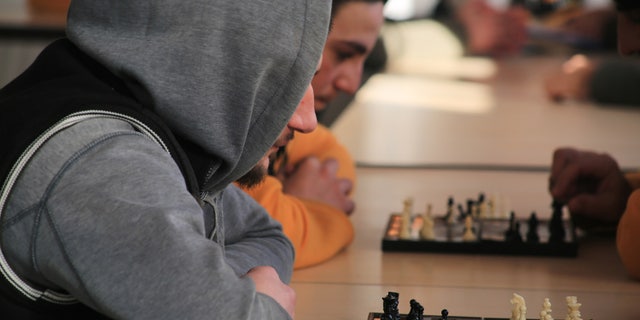 Locals in the "anti-extremist" program engage in a wide array of entertainment activities, including chess
