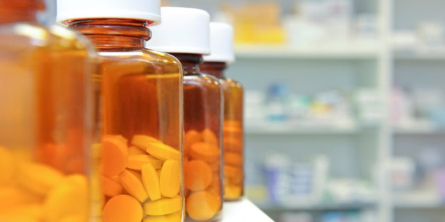 row of bottles and pills on a chemists counter