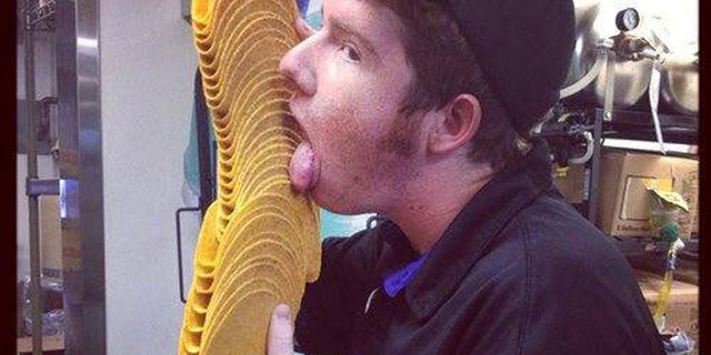 The Irvine-based company said the photograph, above, was taken for a contest showing employees enjoying their first bite of the product. It wasn't submitted, but a worker posted it to a Facebook page, which violates company policy.
