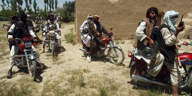 Taliban fighters ride on motorbikes in an undisclosed location in Afghanistan, July 14, 2009. (Reuters)