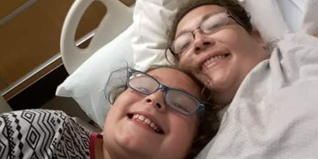 Tammy Owsley-Savard and her daughter pose for a photo.