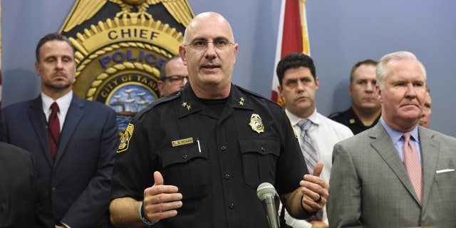 Tampa Police Chief Brian Dugan, center, along with Mayor Bob Buckhorn, right, announce that they intend to charge Howell Emanuel Donaldson, 24, with four counts of first degree murder in connection with the Seminole Heights homicides, Tuesday, Nov. 28, 2017, in Tampa, Fla.