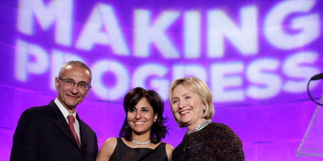 October 24, 2013: Former Secretary of State Hillary Clinton (R) poses with President of the Center for American Progress (CAP) Neera Tanden (C) and CAP founder and Chairman John Podesta at the 10th Anniversary policy forum in Washington.