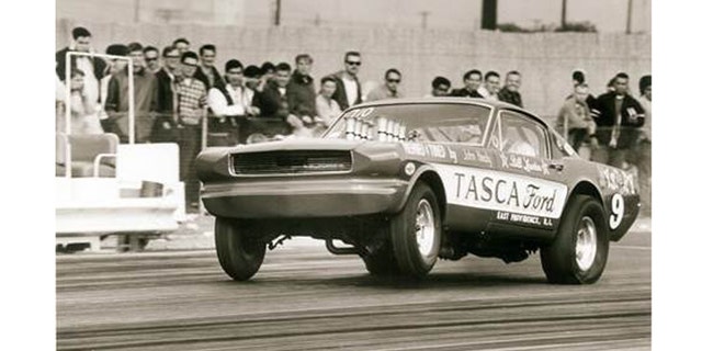 The Tasca Mystery 9 altered-wheelbase Mustang takes a bite of California’s Irwindale Raceway at the 1966 AHRA Winternationals with more than 600-hp worth of Hillborn-injected Ford 427 SOHC “cammer” V-8 authority.