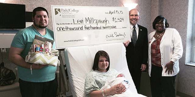 Levi Millspaugh, seen here with mother Kayla (center) and father Aaron (left), received a kick start to his college savings after being the first born on tax day at a Savannah, Ga., hospital. (Memorial Hospital)