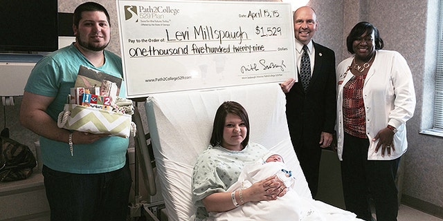 Levi Millspaugh, seen here with mother Kayla (center) and father Aaron (left), received a kick start to his college savings after being the first born on tax day at a Savannah, Ga., hospital. (Memorial Hospital)