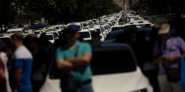 Taxi drivers in Madrid parked their cars and commiserated with their colleagues in the streets.