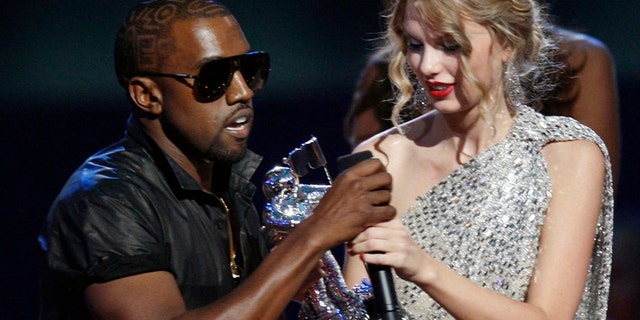 Kanye West takes the microphone from best female video winner Taylor Swift as he praises the video entry from Beyonce at the 2009 MTV Video Music Awards in New York, September 13, 2009. REUTERS/Gary Hershorn (UNITED STATES ENTERTAINMENT IMAGES OF THE DAY) - RTR27T9C