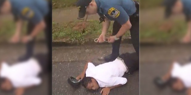 Image from bodycam video showing Timmy Patmon, 23, being handcuffed after being struck by a patrol car driven by Officer Taylor Saulters in east Athens, Georgia.