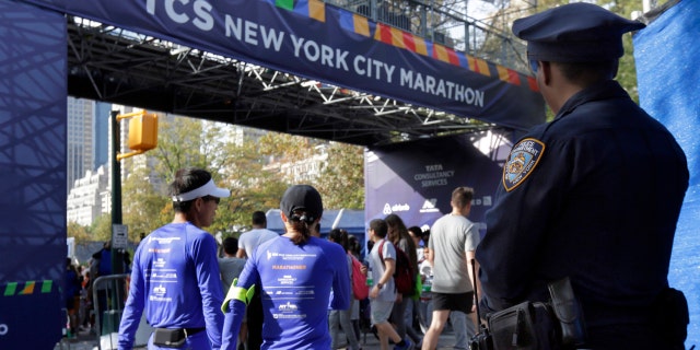 A New York City police office stands near the finish line of the New York City Marathon, in New York's Central Park, Friday, Nov. 3, 2017.