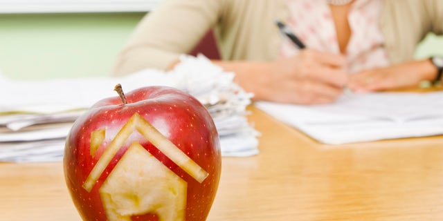 house carved into teacher's apple