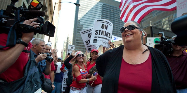 Chicago Teachers Union President Karen Lewis takes a break from negotiations with the Chicago Board of Education to make an unexpected appearance at a rally of thousands of public school teachers on Tuesday, Sept. 11, 2012 in Chicago. Teachers walked off the job Monday for the first time in 25 years over issues that include pay raises, classroom conditions, job security and teacher evaluations. (AP Photo/Sitthixay Ditthavong)