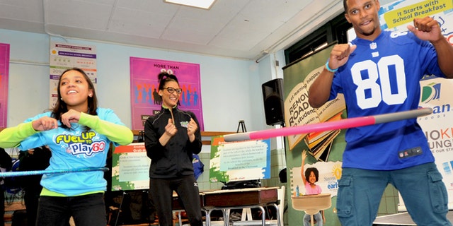 New York Giants star Victor Cruz practices his hula hoop skills while participating in the NFL's Fuel Up to Play 60.