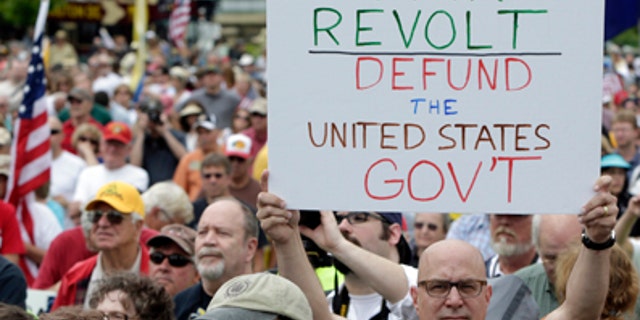 June 19, 2013: A man holds up a placard during a Tea Party rally to "Audit the IRS" in front of the U.S. Capitol in Washington.